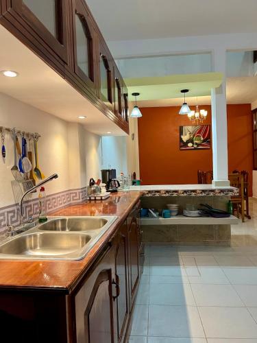 a kitchen with two sinks and a counter top at La casa de los Faroles in Cuetzalán del Progreso