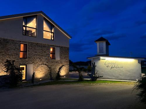 a building with a sign on the side of it at Casal de pelaio in Barreiros