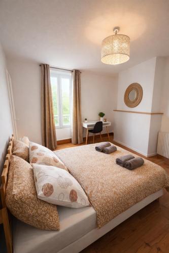 a bedroom with a bed with two pillows on it at Maison de rue: Auch in Auch