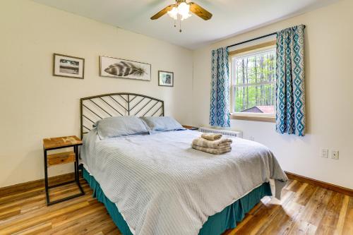 a bedroom with a bed and a window at Peaceful Wooded Retreat at Lake Wallenpaupack! in Lake Ariel