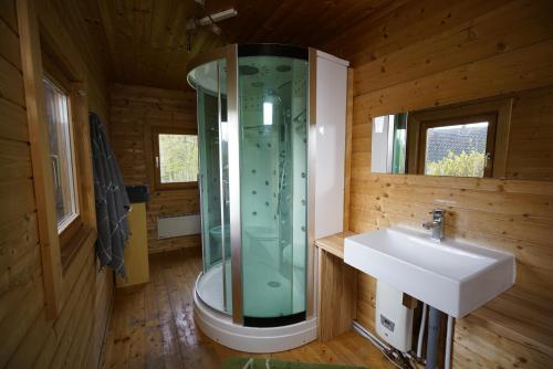 a bathroom with a glass shower and a sink at Camp Sibley Hütte in Oberdambach