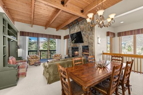 a dining room and living room with a wooden table at 229 #35 by SkyRun Aspen in Snowmass Village