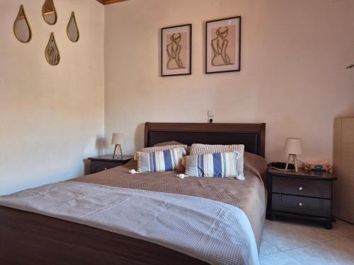 a bedroom with a large bed with two night stands at Afroditi's 1 in Eresos