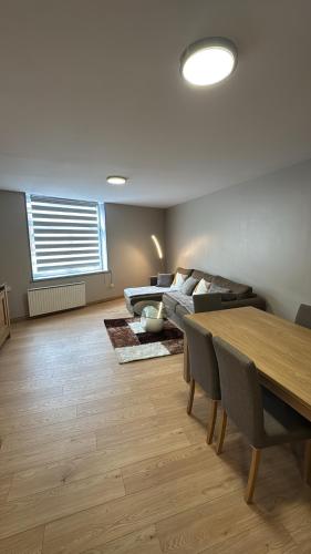 a living room with a table and a couch at Superbe Duplex T2 62m2 - Rénové à Neuf ! in Croix