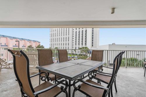 a wooden table and chairs on a balcony at TOPS'L Tides 0207 in Destin