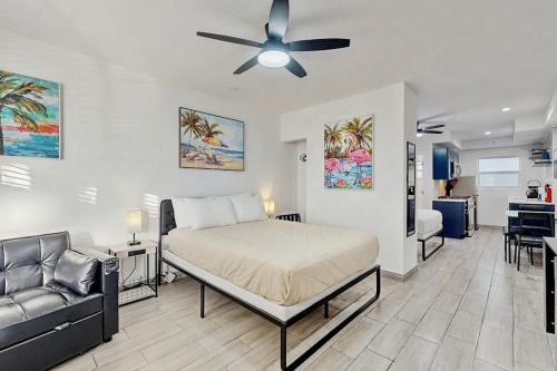 a bedroom with a bed and a couch at Sunshine, Beach & Smiles on Ocean Drive in Miami Beach