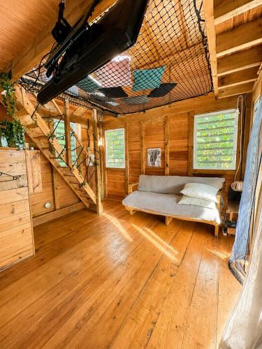 a room with a bed and stairs in a house at evasion guadeloupe in Malgré Tout