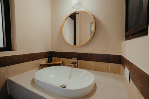 a bathroom with a white sink and a mirror at Taura Wellness House - Boutique Stay & Experiences in Antigua Guatemala in Antigua Guatemala