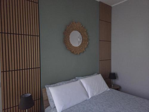 a bedroom with a bed and a mirror on the wall at Cà Fiamma 1 in Casale Monferrato