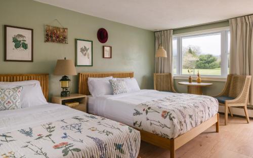 a bedroom with two beds and a window at Gale River House - Boutique Hotel in Franconia