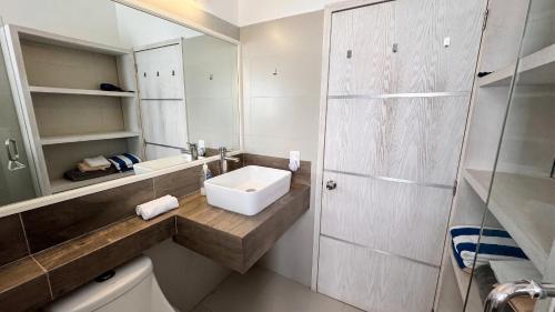a white bathroom with a sink and a toilet at La Marina Condominiums by Monyxbnb in Puerto Vallarta