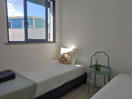 a bedroom with two beds and a window at Estoril Sun in Estoril