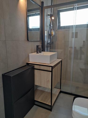 a bathroom with a white sink and a shower at Estoril Sun in Estoril