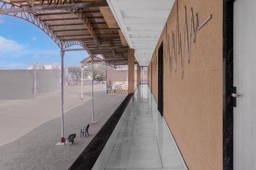 an empty building with a tennis court in the background at Hotel O Dwarkadhish in Surat