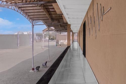 an empty building with benches on the beach at Hotel O Dwarkadhish in Surat