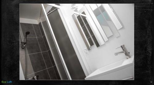 a bathroom with a sink and a mirror at Le Loft des Remparts in Murat
