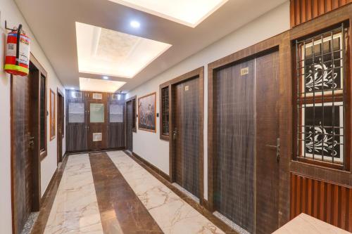 a corridor with doors and windows in a building at HOTEL O PRAGATI in Gorakhpur