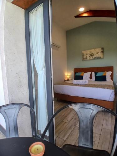 a bedroom with a bed and a table and chairs at The Olive Hill Guesthouse in Batalha