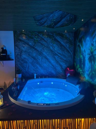 a bath tub in a room with a fish tank at Moonlight Jungle Suit Luxury experience in Avola