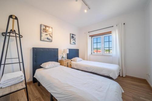 a room with two beds and a ladder in it at Quinta da Mina 13 in Azambuja