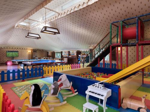 a childrens play area with a slide and play equipment at Raffles Udaipur in Udaipur