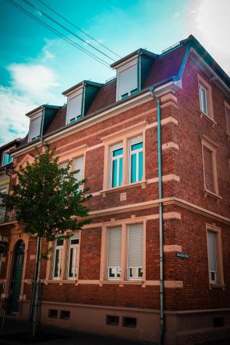 a red brick building with colorful windows on it at Hotel Grünshof in Walldorf