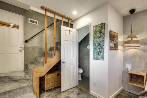 a bathroom with a staircase and a toilet and a stair case at 2 Mi to Lake Gregory! Chic Crestline Base Camp in Crestline