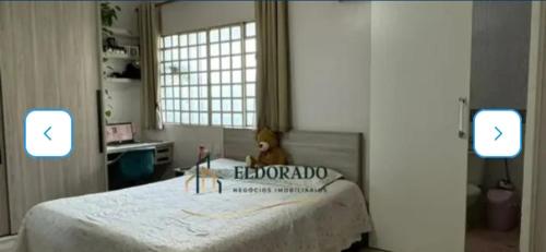 a bedroom with a bed with a stuffed animal on it at Nosso lar hostel in Cuiabá