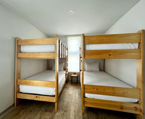 two bunk beds in a room with a attic at Awqa Loft & Camp in Trujillo