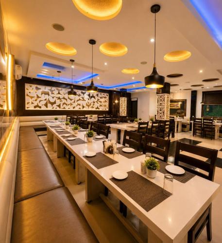 a restaurant with tables and chairs and a bar at Hotel Pleasant Taj Agra -Budget Family AC Rooms in Tājganj