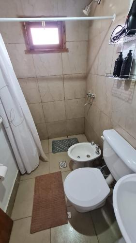 a small bathroom with a toilet and a sink at Dúplex céntrico LAS SOFIAS - PURMAMARCA in Purmamarca