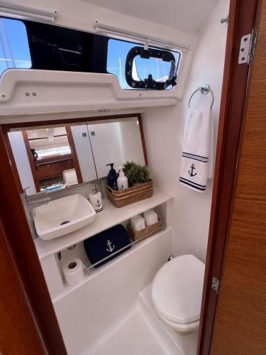 a small bathroom with a toilet and a sink at Voilier Bermuda By Villa AGADA in Gourbeyre