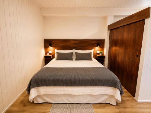 a bedroom with a large bed and two night stands at Loft y Parking Centro de Melipilla in Melipilla