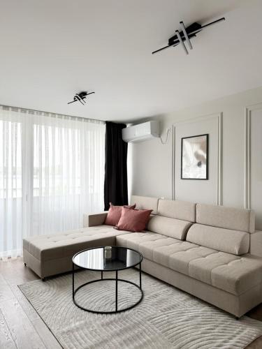 a living room with a couch and a table at Zafiro Apartment, City Center in Kavadarci