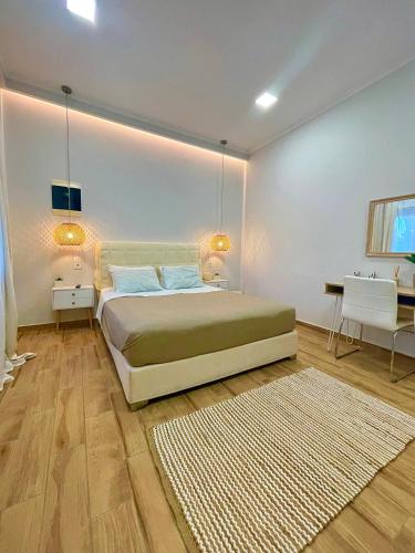 a bedroom with a bed and a table and a desk at Elia Room & Garden in Kontokali