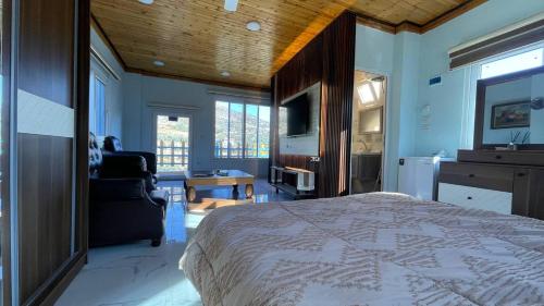 a bedroom with a large bed and a bathroom at Bab al-qalaa farm & chalets مزرعة وشاليهات باب القلعه in Ajloun