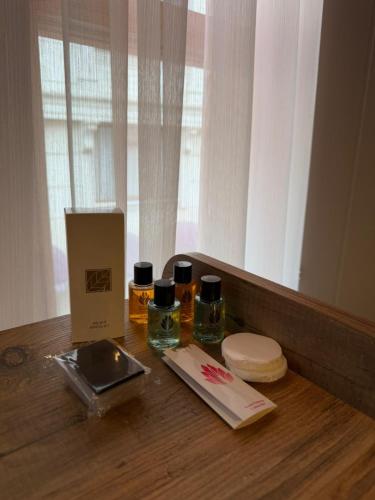 a table with two bottles of essential oils and a box at Mirello House Otel Tuzla in Tuzla