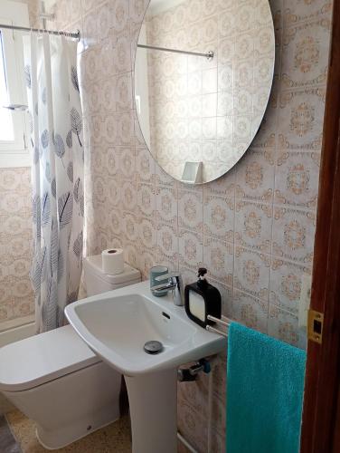 a bathroom with a sink and a mirror at Apartamentos Escorpion Tossa de Mar in Tossa de Mar
