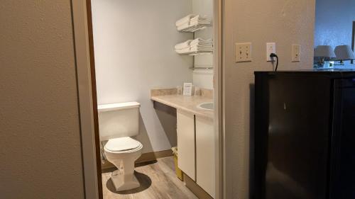 a small bathroom with a toilet and a sink at Moby Dick Inn in Prince Rupert
