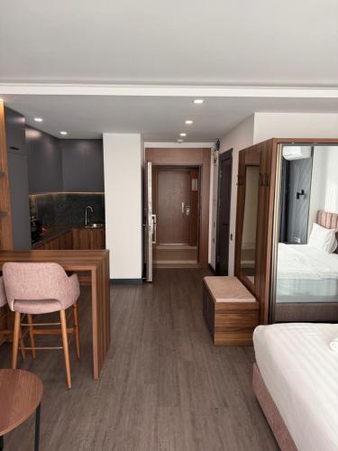 a hotel room with a bed and a desk and a bedroom at Batumi View Luxury in Adliye