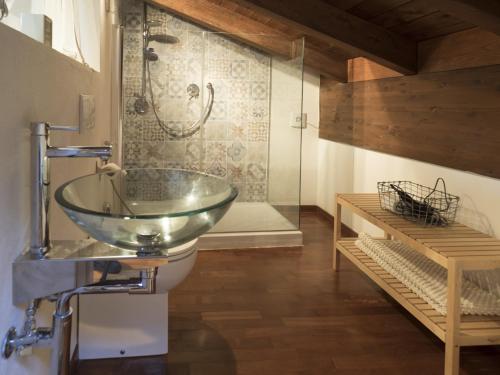 a bathroom with a glass bowl sink and a shower at Locanda Castel De Britti in San Lazzaro di Savena