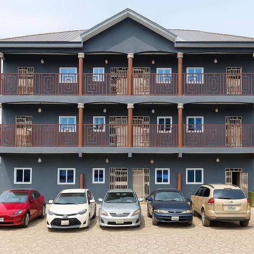 a group of cars parked in front of a building at Cj apartment kasoa in Kasoa