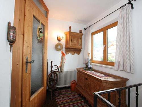 a hallway with a wooden door and a window at Veronika in Fulpmes