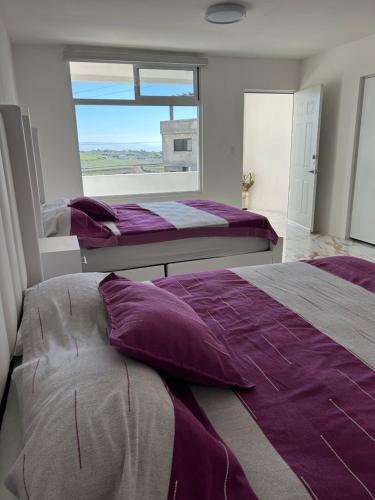 two beds in a bedroom with a window at Mar de Calafia 1 in Divisadero