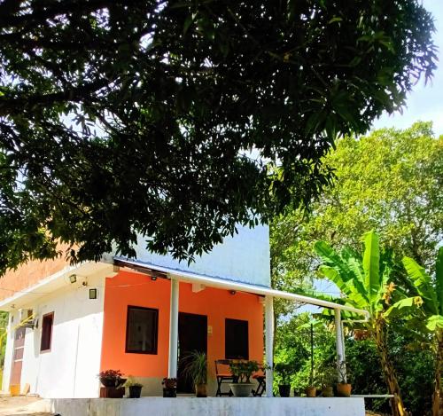 a house with an orange and white at Abelha & Peixe Boi in Santo Amaro