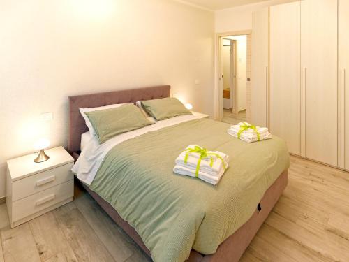 a bedroom with a large bed with towels on it at Assisi valley - Modern Apartment with Covered Parking in Bastia Umbra