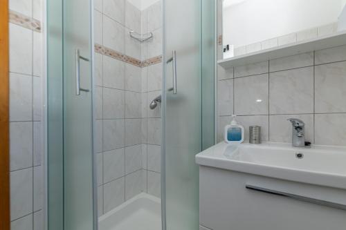 a bathroom with a shower and a sink at Apartment Zavala 553d in Jelsa