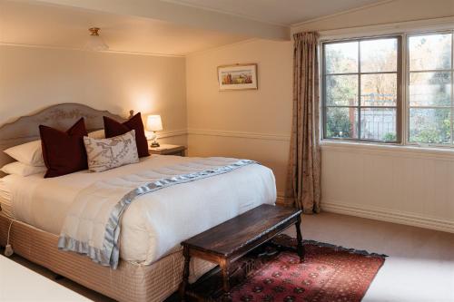 a bedroom with a large bed and a window at Aldourie Lodge - Lake Tekapo in Lake Tekapo