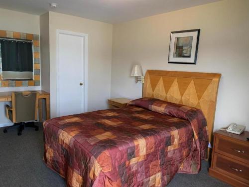 a hotel room with a bed and a desk at Nitey Nite Motel in South Windsor