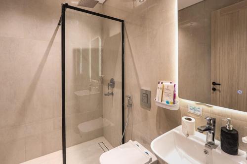a bathroom with a shower and a toilet and a sink at دار المصطفى in Al-Salam